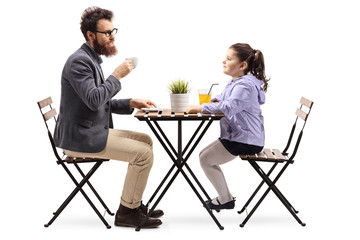 Wall Mural - Father and daughter at a cafeteria drinking coffee and orange juice