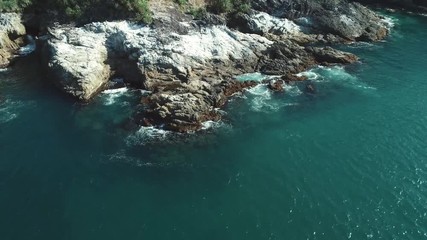 Wall Mural - Aerial drone shot of sea cliffs off the coast on sunny day