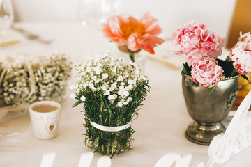 Wall Mural - Little vases with autumn flowers stand on the table