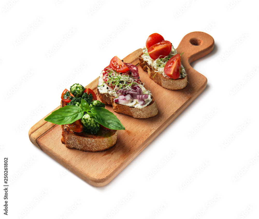 Board with fresh tasty bruschettas on white background