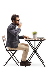 Bearded man drinking coffee at a table