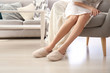 © Pixel-Shot - Young woman in slippers at home
