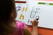 © globalmoments - Kid learning how to write the abc's at home.