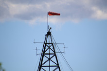 A Weather Station With A Red Wind Sock