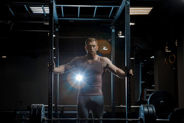 Wall Mural - Strong man posing in gym