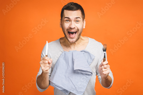 Fotomural Young hungry crazy man holding a fork and a knife