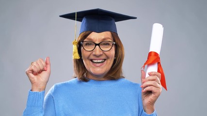 Wall Mural - graduation, education and old people concept - happy senior graduate student woman in mortar board with diploma laughing over grey background