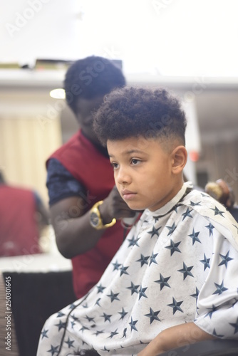 Boy In The African Barbershop Cute Mixed Boy Makes A Haircut In