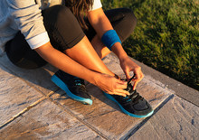 Young Woman Tying Shoelace Of Sneakers To Make Outwork Training Running. Fitness And Healthy Lifestyle