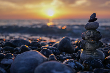 hareubang pebble reflection at sunset over the sea - zen and relaxation