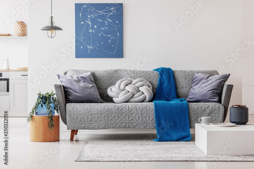 Blue blanket and grey knot pillow on Sofa Knotted Pillow at