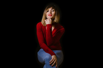 blonde woman posing on black background