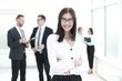 © yurolaitsalbert - Portrait of happy young business woman over office background