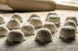 © Алексей Еремеев - Uzbek national food Chuchvara, like dumplings, with a rolling pin, on a wooden board, in flour