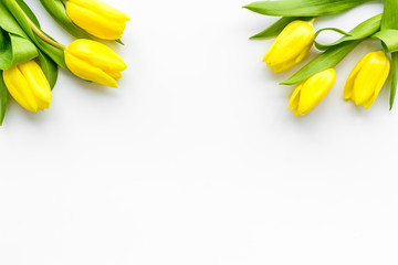 Poster - Spring composition. Delicate yellow tulips on white background top view copy space border