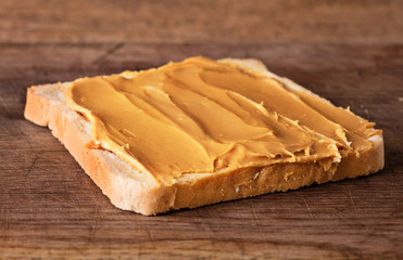 Wall Mural - peanut butter sandwich on wooden background