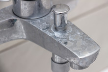 Close-up Of Shower Mixer Faucet With Limescale, White Chalky Deposit And Stains. Formed On The Plumbing System By A Combination Of Soap Residues And Hard Water. Concept Of Cleaning Limescale Plumbing