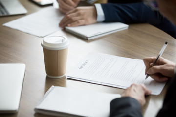 Poster - Male and female partners sign two contracts at meeting, closeup