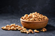 cashew nuts  in wooden bowl on black background  ,close-up