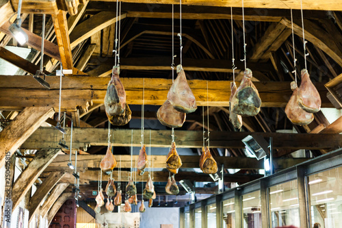 Hooked Ham On Wooden Beams That Hang From The Ceiling