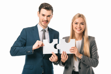 smiling businesspeople holding puzzle pieces isolated on white, business strategy concept