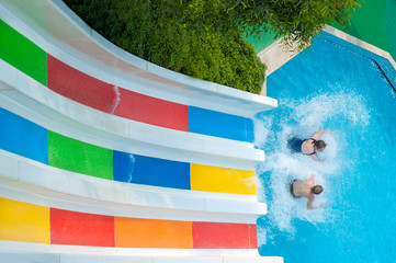 couple man and woman ride with colorful water slides. family activities