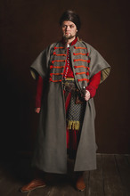Portrait Of A Man In A Medieval Costume On A Dark Background. Clothes Of The Polish Gentry.