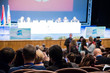 © Andrey Lapshin - Defocused image. People in the auditorium. International conference. Flags of different countries on stage.