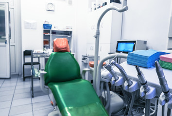 Dentist's office, oral hygiene, dental instruments close-up. The medical office is equipped with an armchair and special lighting for dental treatment.