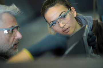 Wall Mural - Metalworker with apprentice in workshop