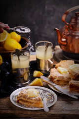 Wall Mural - Pieces of lemon pie on a plate and tea in glasses