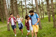 © BGStock72 - Group of four friends hiking together through a forest