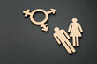 Female and male figures with symbol of transgender on dark background