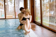 © BGStock72 - Loving couple relaxing in the spa by swimming pool