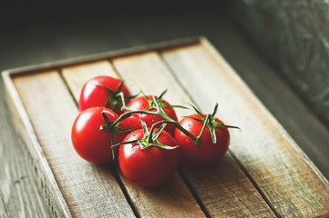 Natural texture of ripe juicy red tomatoes close-up and copy space. Tomatoes on a dark background, the concept of healthy food, toned photo