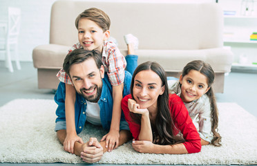 Young happy family relax together at home smiling and hugging