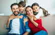 © My Ocean studio - Young happy family relax together at home smiling and hugging