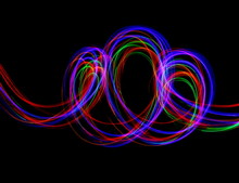 Long Exposure, Light Painting Photography.  Abstract Multi-color Design, Vibrant Color Against A Black Background