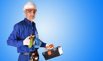 Wall Mural - Uniformed electrician with safety protections and work tools background