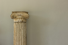 Antique Marble Column From Ancient Greece Times Exhibit Object On White Wall Background Texture With Empty Copy Space For Your Text Or Inscription