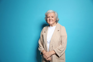 Wall Mural - Portrait of elderly woman on color background