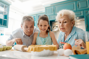 Wall Mural - Grandparents and curious granddaughter