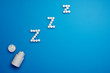 Tablets, hormone and excipients to improve sleep on blue backgroung.