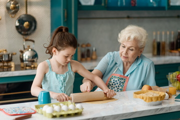 Wall Mural - Granny teaches granddaughter to bake