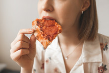 Close Up Girl's Photo Bites A Piece Of Appetizing Pizza. Woman Eating Pizza Close Up. Background