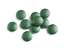 Spirulina Tablets On White Background, Top View. Healthy Lifestyle
