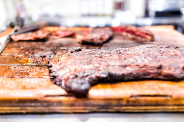 Fresh fried grilled browned cooked skirt flank strip steak on wooden rustic chopping board grease well-done marinated