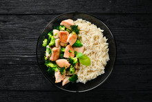 Rice With Chicken Fillet And Vegetables. Top View. On A Black Background. Free Copy Space.