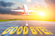 © aapsky - Good luck written on runway airport, and the airplane take off into the sunset. Concept of departure return home