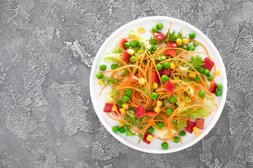 Sticker - Fresh vegetable salad with raw carrot, green peas, corn, sweet pepper and lettuce. Healthy vegan, vegetarian lunch menu. Top view